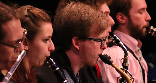 Student band performance featuring flute, clarinet and saxophone players.