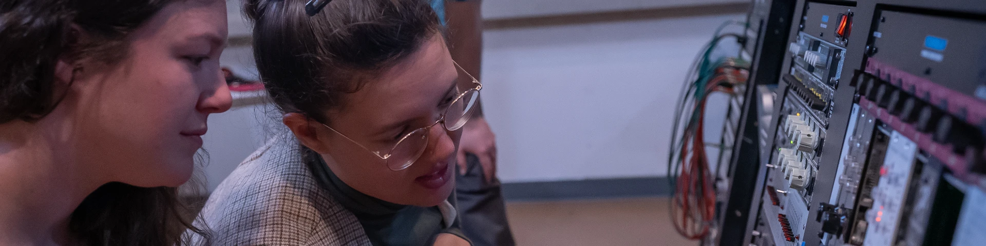 Two music students work with a soundboard in CCC's recording studio