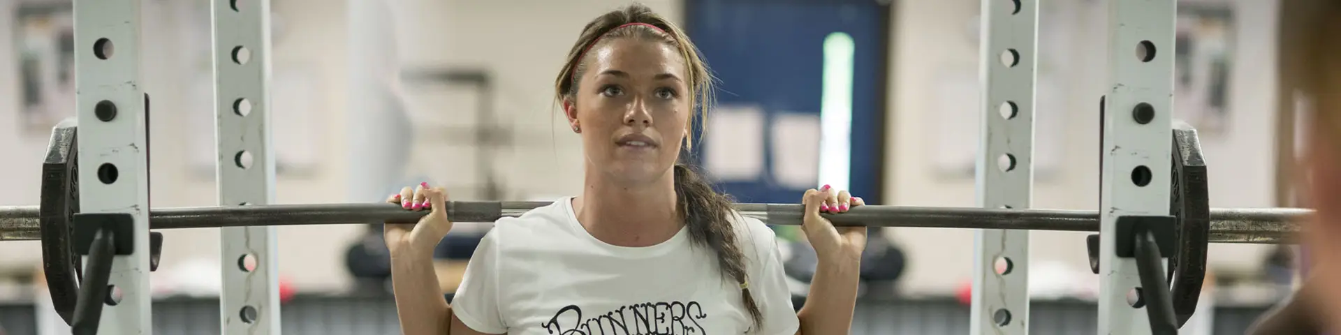 Student lifting weights in the gym on Clackamas Community College's Oregon City campus
