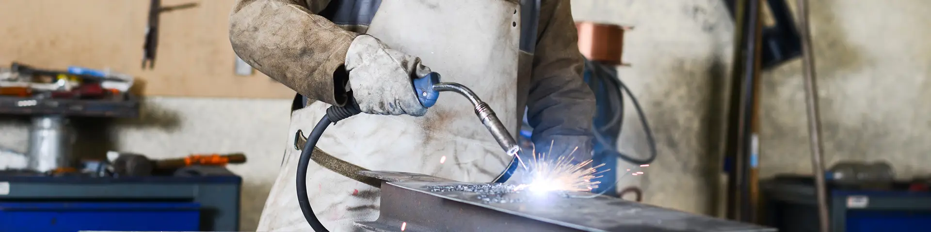 A student doing welding work on a beam.