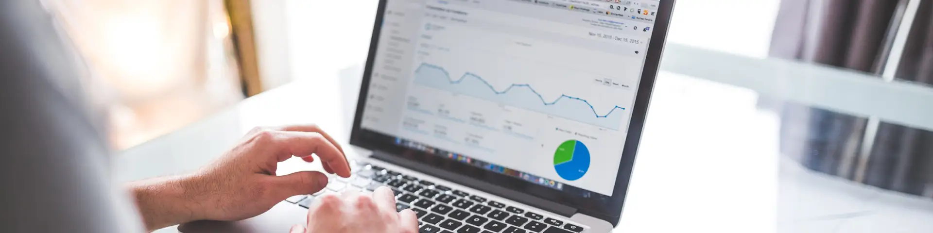 Open laptop with person looking at marketing data in Google Analytics.