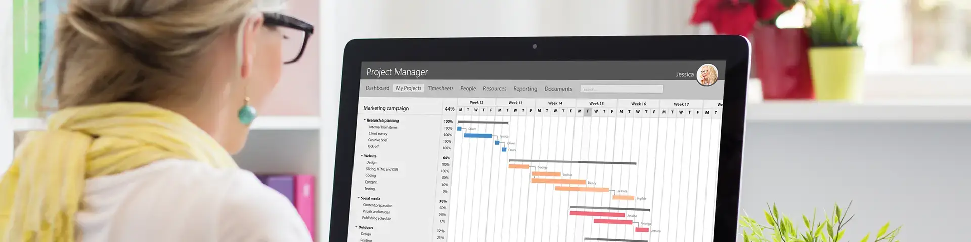 Woman using project management software to chart the tasks and timelines of a project.