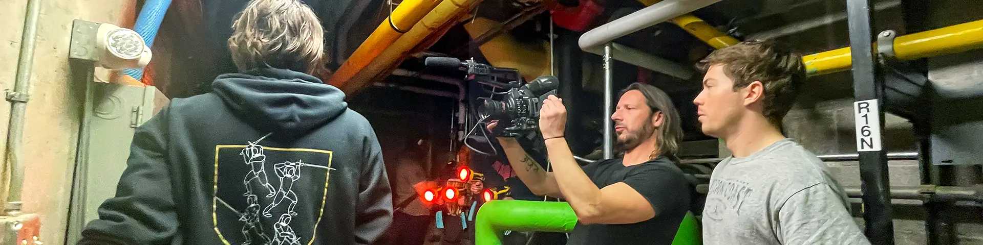 Student video camera operator examines a scene through the camera's viewfinder
