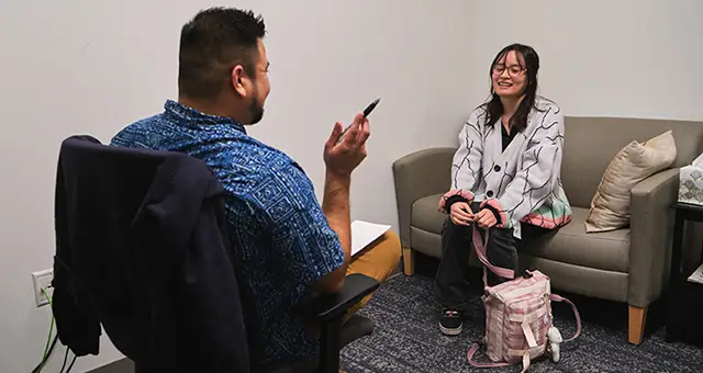 Counselor meets with a student in a counseling office in the Wacheno Welcome Center on CCC's Oregon City campus