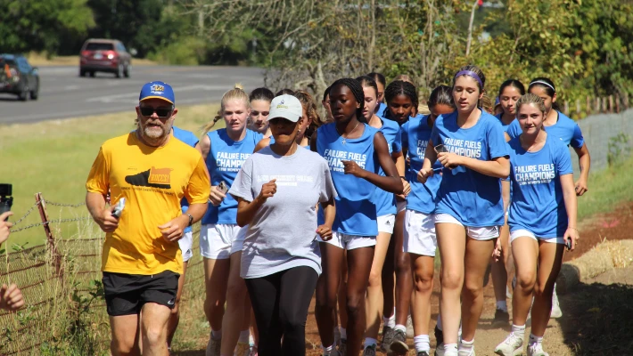 Cook_with_soccer_team President Tim Cook runs with Lane Community College women's soccer team